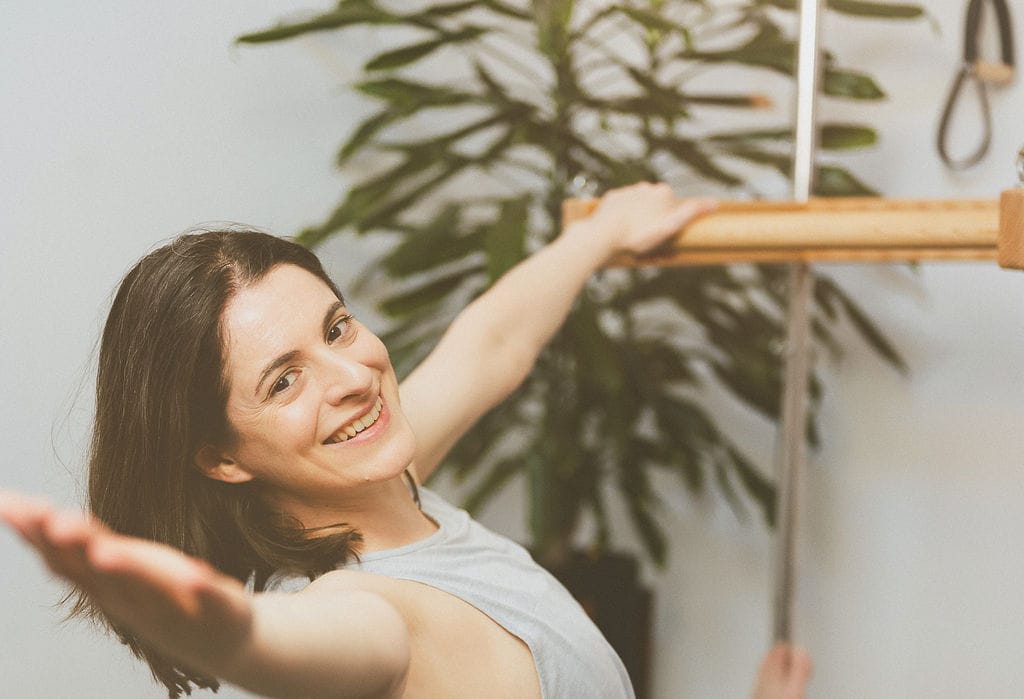 MelanieChristou-26a Melanie smiling looking welcoming whilst doing a Pilates exercise